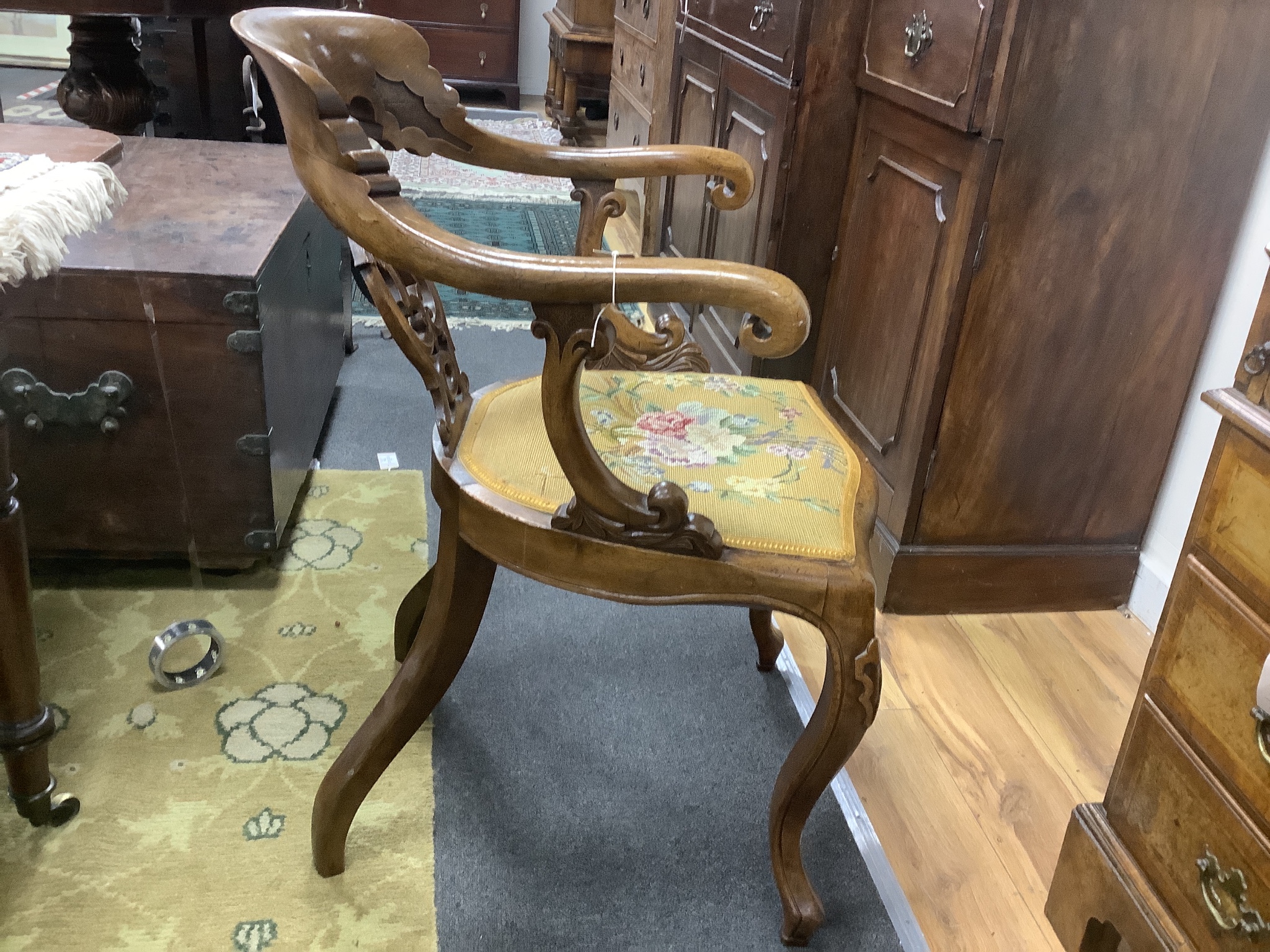 A Victorian carved walnut elbow chair, width 58cm, depth 48cm, height 90cm